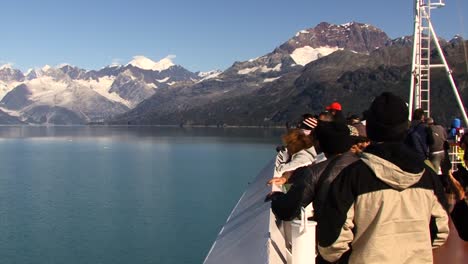 Passengers-in-the-bow-of-the-ship-admiring-the-landscape-of-Alaska