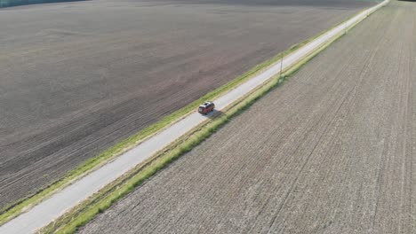 volkswagen-vanagon-camper-van-driving-through-corn-crop-field-adventure-road-trip-aerial-drone