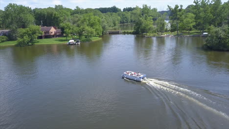 Drone-Shot-of-a-Pontoon-Boat-on-Lake-Shannon,-Michigan