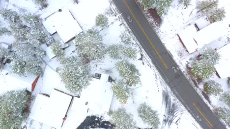 Residential-top-down-drone-footage-during-a-spring-snow-storm-in-Big-Bear,-California