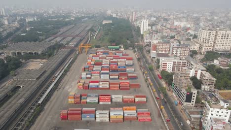 Aerial-4K-of-shipping-container-depot-close-to-railway-station-in-Dhaka-city,-Bangladesh-industry
