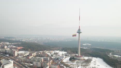 AERIAL:-Vilnius-in-Background-with-TV-Tower-and-Waving-Lithuanian-Flag