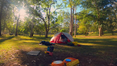 Time-Lapse-of-a-man-packing-up-his-tent-after-a-camping-trip-during-the-morning