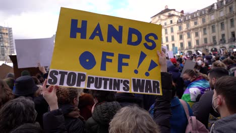 Hands-of-Ukraine-is-written-on-sign-at-anti-war-demo-in-Munich,-Germany,-after-Russia-invades-Ukraine