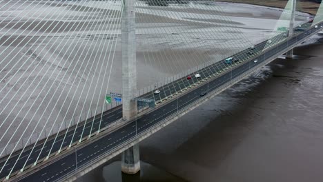 Mersey-gateway-landmark-aerial-view-above-toll-suspension-bridge-river-crossing-descending-reveal-shot