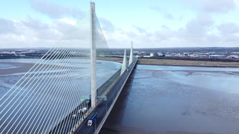Mersey-gateway-landmark-aerial-view-above-toll-suspension-bridge-river-crossing-high-tilt-down-shot
