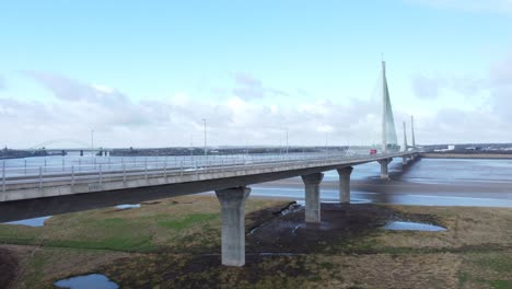Mersey-gateway-landmark-aerial-view-above-toll-suspension-bridge-river-crossing-slow-rising-shot