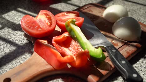 Slices-Of-Tomato,-Onion,-Red-And-Green-Bell-Peppers-On-a-Wooden-Chopping-Board
