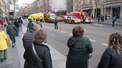 Residents-look-with-curiosity-a-police-and-medical-emergency-evacuation-exercise-drill-in-Madrid,-Spain