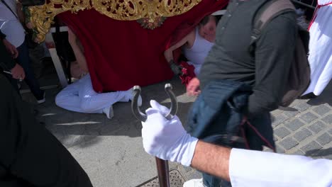 Penitents-take-a-rest-during-a-procession-to-celebrate-the-Holy-Week-in-Cadiz,-Spain