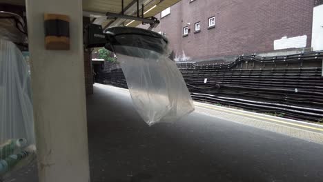 Empty-See-Through-Waste-Bag-Waving-In-The-Wind-On-Platform-At-Finchley-Road-Station-In-London-On-12-May-2022