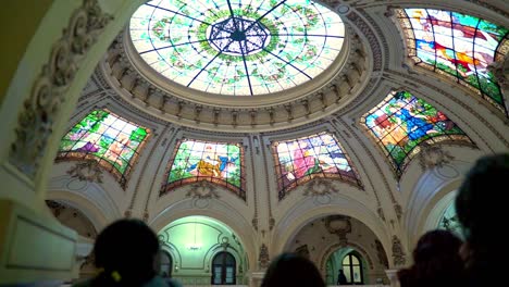 Handheld-of-a-group-of-people-admiring-the-stained-glass-windows-of-the-cupola-of-the-Intendencia-de-Santiago,-current-seat-of-the-Presidential-Delegation,-Santiago,-Chile