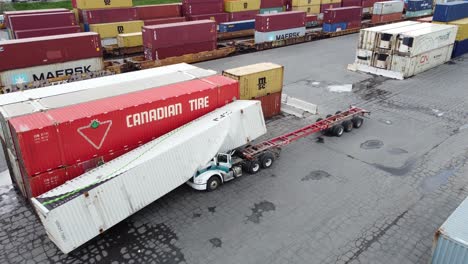 Aerial-shot-of-cargo-freight-containers-on-ground-after-heavy-storm