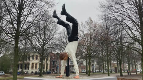 Statue-of-a-businessman-with-a-briefcase-doing-a-handstand-celebrating-his-freedom