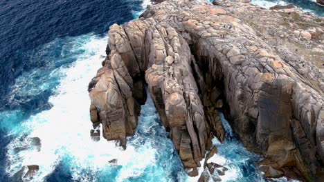 Aerial-bird's-eye-view-of-steep-cracked-rocky-cliff-in-Morás,-Xove,-Lugo,-Galicia,-Spain-at-daytime