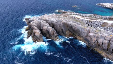 Scenic-overview-of-extreme-waves-splashing-on-the-rugged-cliff-called-paper-cliffs-in-Costa-Da-Morte,-Morás,-Xove,-Lugo,-Galicia,-Spain-at-dayitme