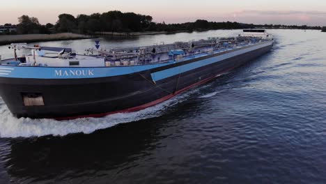Manouk-Oil-Tankership-Traveling-Across-Waterways-In-Netherlands-At-Dusk