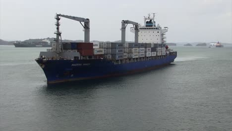 Container-ship-transiting-Gatun-lake,-Panama-Canal