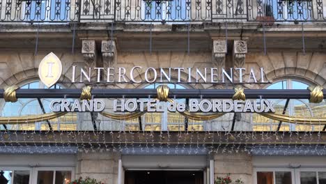 Front-sign-of-the-intercontinental-hotel-on-a-clear-morning-with-elaborate-metal-text-design,-Handheld-shot