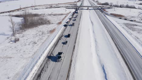Aerial-overhead-swoops-up-to-shows-traffic-in-freedom-convoy-and-supporters-on-overpass-at-hwy-138-and-hwy-417-near-moose-creek-ontario