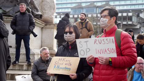 Hong-Kong-couple-holding-message-at-Ukraine-anti-war-protest-activists-on-Manchester-city-street