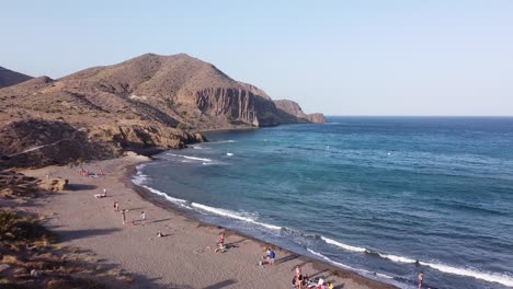 Playa-del-Penon-Blanco-Beach-at-San-Jose,-Cabo-de-Gata,-Almeria,-Andalucia,-Spain---Aerial-Drone-View-of-the-sandy-beach-and-the-rocky-coastline