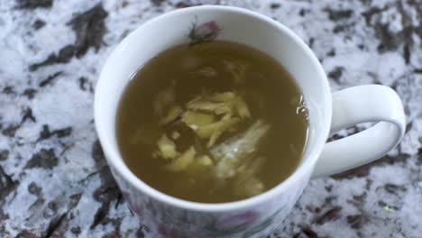 Swirling-Ginger-And-Lemon-Pieces-In-Honey-Hot-Drink