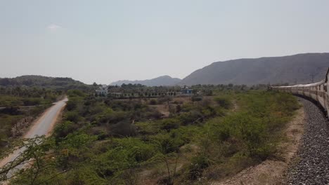 On-Ride-Shot-Taken-From-the-Open-Door-Of-An-Indian-Moving-Train-In-Rajasthan-During-Summer-Day,-India-Landscape