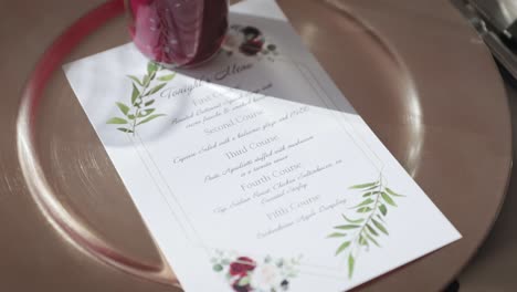Gold-plate-and-menu-place-setting-for-a-dinner-at-a-wedding-venue