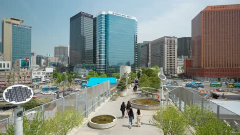Seoullo-7017-sky-park-walkway-with-people-walking-around-and-Seoul-city-skyline