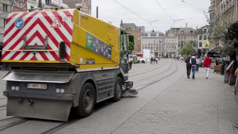 Garbage-truck-passing-the-city-streets-after-cleaning-in-Ghent,-Belgium