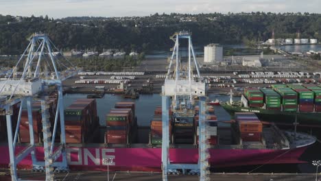 Business-Logistic-Import-And-Export-Freight-Transportation-By-Container-Ship-In-Harbor,-The-Husky-Terminal,-Tacoma-Port-In-Washington,-USA---aerial-sideways