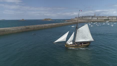 Drone-footage-of-the-corsair-boat-"Le-Renard"-in-the-port-of-Saint-Malo,-Bretagne,-France