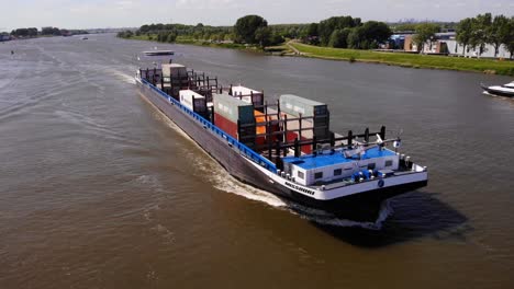 Missouri-Cargo-Barge-And-Yacht-Sailing-On-The-Murkey-Water-Of-Oude-Maas-In-Zwijndrecht,-Netherlands