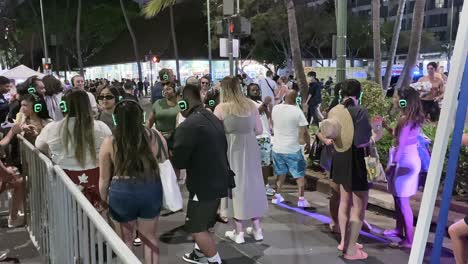 People-dancing-to-music-through-headphones-in-Waikiki-festival