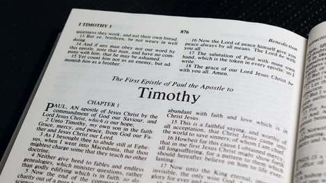 Close-Up-Shot-of-Bible-Page-Turning-to-the-book-of-First-Timothy