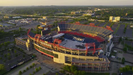 Aerial-view-towards-the-Nissan-Stadium,-sunny,-summer-evening-in-Nashville,-USA---tilt,-drone-shot