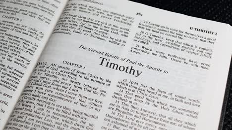 Close-Up-Shot-of-Bible-Page-Turning-to-the-book-of-Second-Timothy