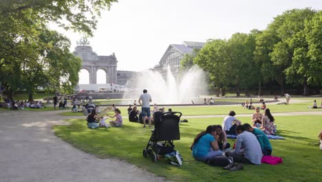 People-relax-on-the-green-lawn-over-the-Brussels-skyline-in-Jubelpark