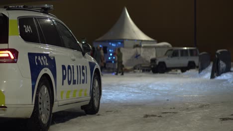 Helsinki-Police-car-in-snowy-night-parking-lot-during-LUX-Festival
