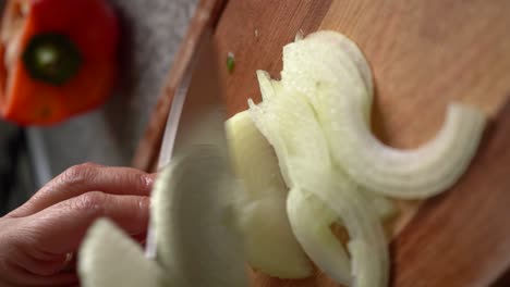 Vertical-Shot-Of-A-White-Onion-Chopped-Using-Sharp-Knife-At-Home