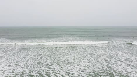 Drone-video-of-surfers-paddling-out-to-sea