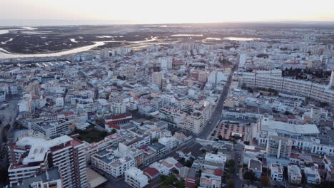 Faro-Cityscape-Aerial-View-Ria-Formosa-in-Background,-Sunset,-Dolly-In
