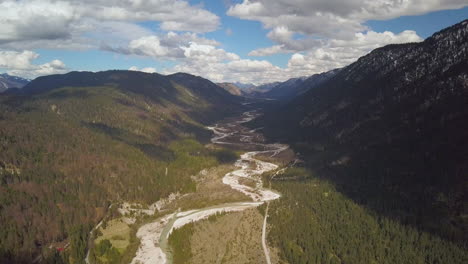 Aerial-view-following-shallow-river-Isar-terrain-flying-high-above-Hinterau-valley-Tyrol-Austria
