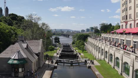 Rideau-Canal-Locks-near-Parliament-Hill,-Ottawa-leading-to-Ottawa-River-on-a-sunny-summer-day-before-Canada-Day-2022---4K-slow-motion