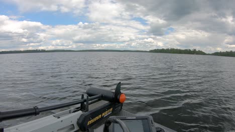 Trolling-motor-on-front-deck-of-fishing-boat-while-rapidly-planing-over-open-waters-of-Lake-Vermilion-in-northern-Minnesota