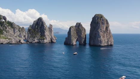 Faraglioni-Rock-Sea-Stacks-on-Coast-of-Capri-Island,-Italy---Aerial
