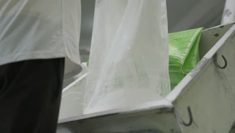 Plastic-Manufacturing-Process,-Worker-Empties-Polymer-Bag-For-Extrusion