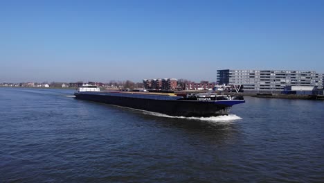 Yemaya-Inland-Freight-Ship-Sailing-On-Noord-River-With-Urban-Landscape-In-Background-At-Netherlands