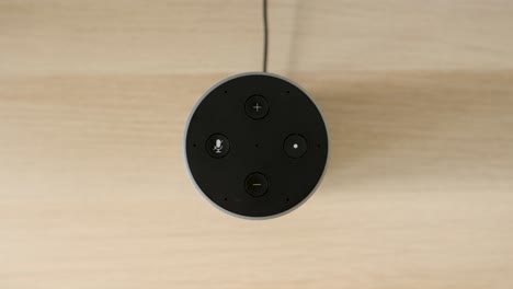 Voice-Activated-Smart-Home-Device-Turns-On,-top-down-close-up